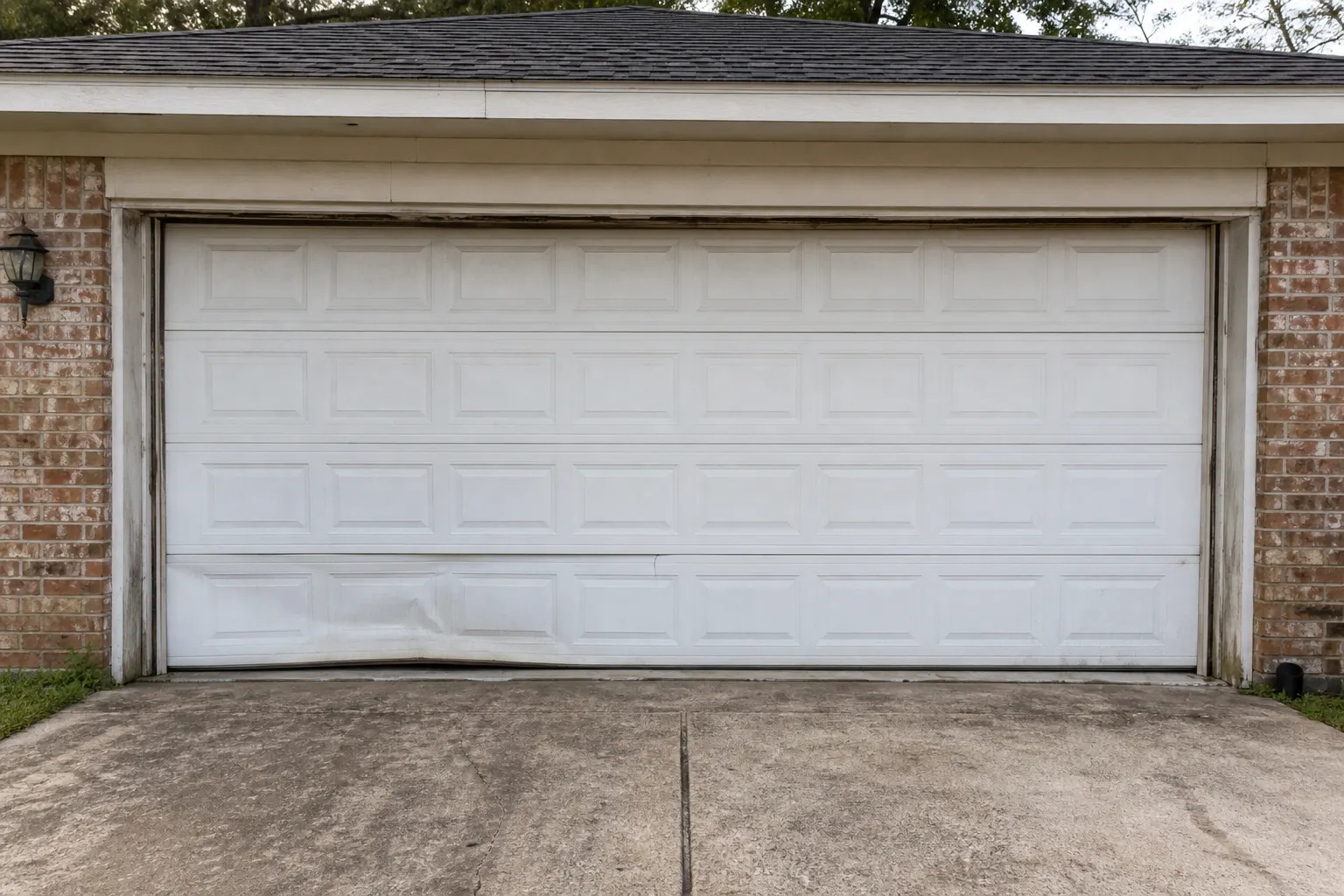 Garage door before repair Worn garage door before repair in Humble TX